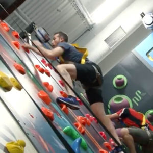Child climbing a colorful wall at Play Climb.