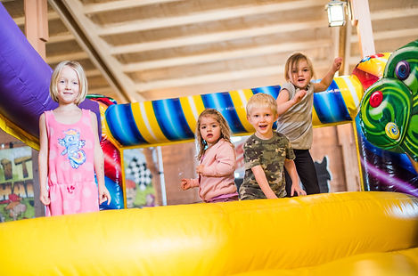 Children playing in a bounce-house area at Holt Stage Hideaway.