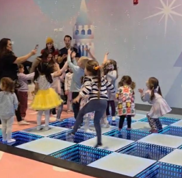 Children dancing together on the LED interactive dance floor at Hyper Kidz Niles.