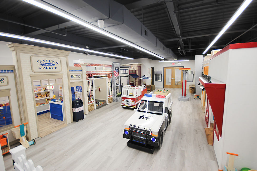 Pretend-play stations and open floor area at Imagination Lane.