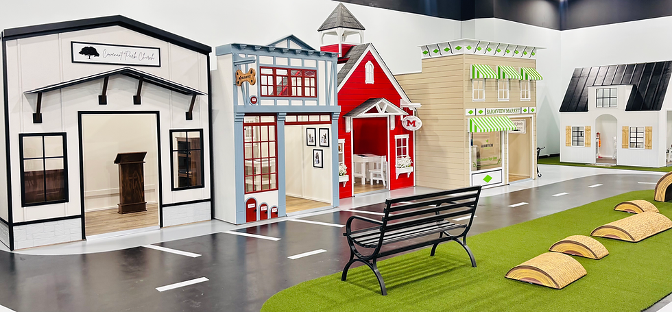 A wide view of the mini indoor play village at Imagine That.