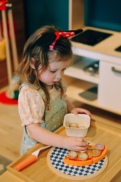 Child-sized pretend kitchen setup at Inspired Play Cafe.
