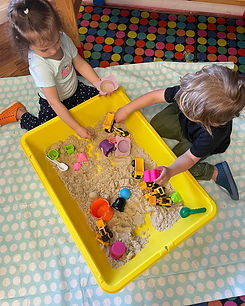 Two young children playing in a sensory bin at Island Art Spot