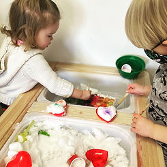 Toddlers using a tabletop sensory setup at Island Art Spot
