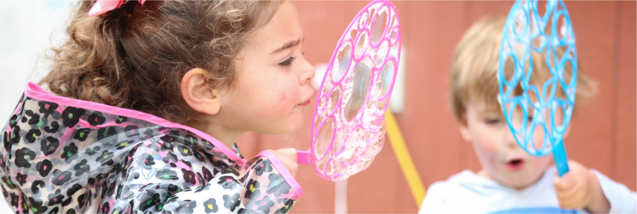 Children playing with giant bubble wands during a Jackson Hole Children's Museum visit.