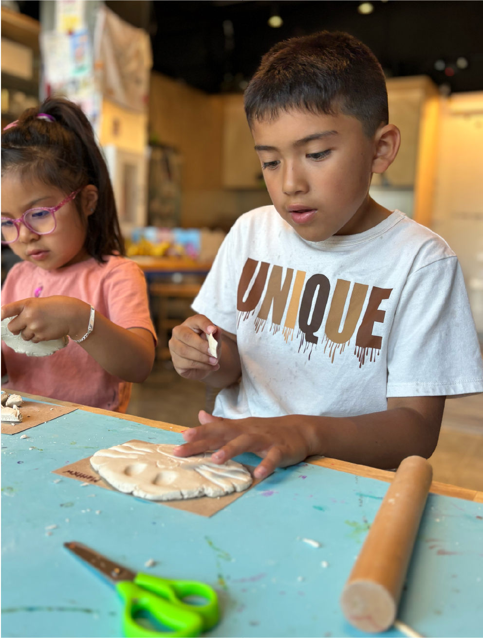 Children shaping clay at a Jackson Hole Children's Museum activity table.