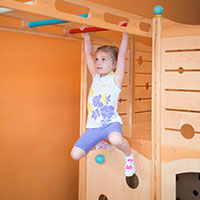 Child climbing on age-appropriate indoor play equipment at Jam Time.
