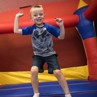 Child playing in a bouncy play area at Jam Time.