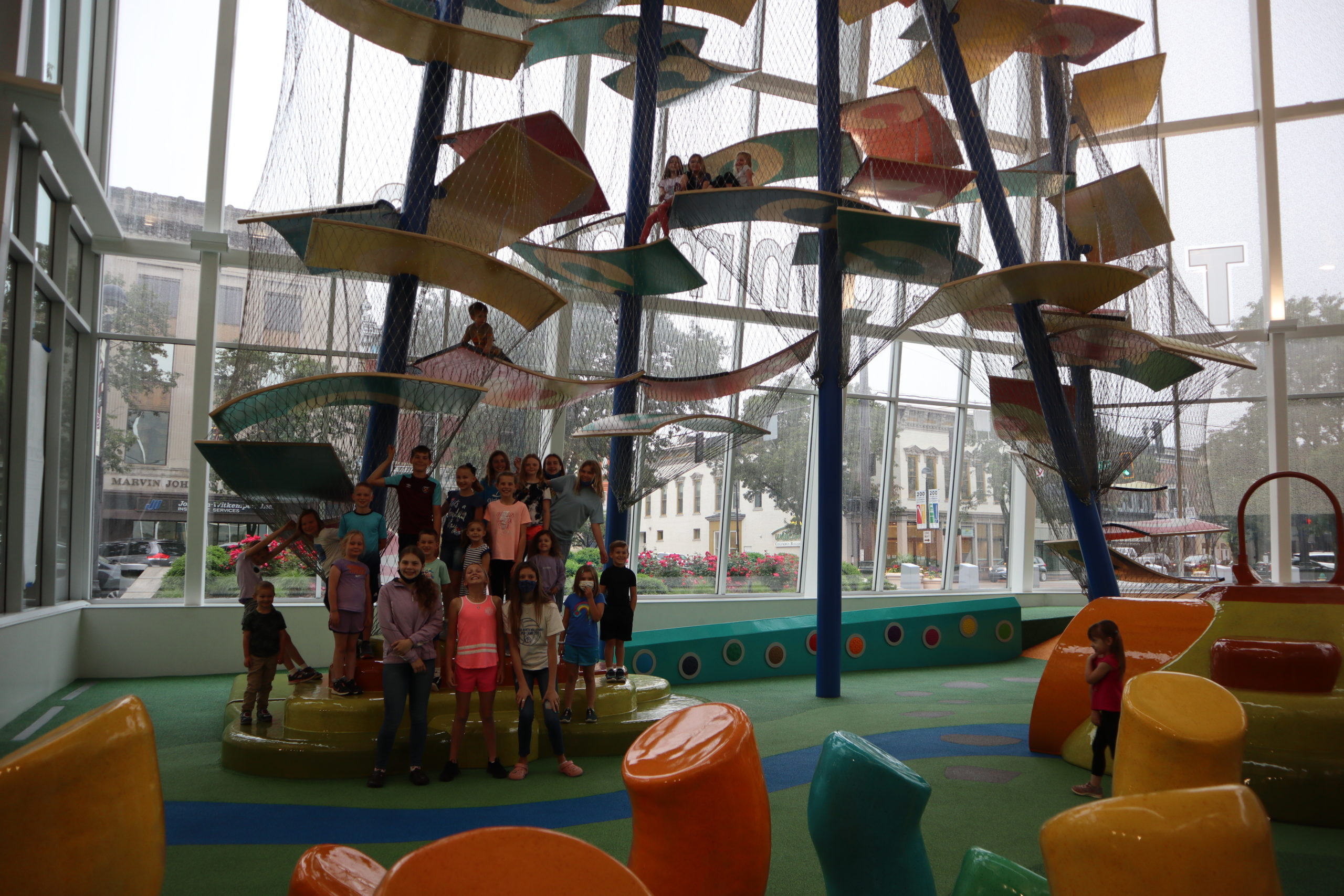Large indoor climbing structure and open play area at James A. Henderson Playground.