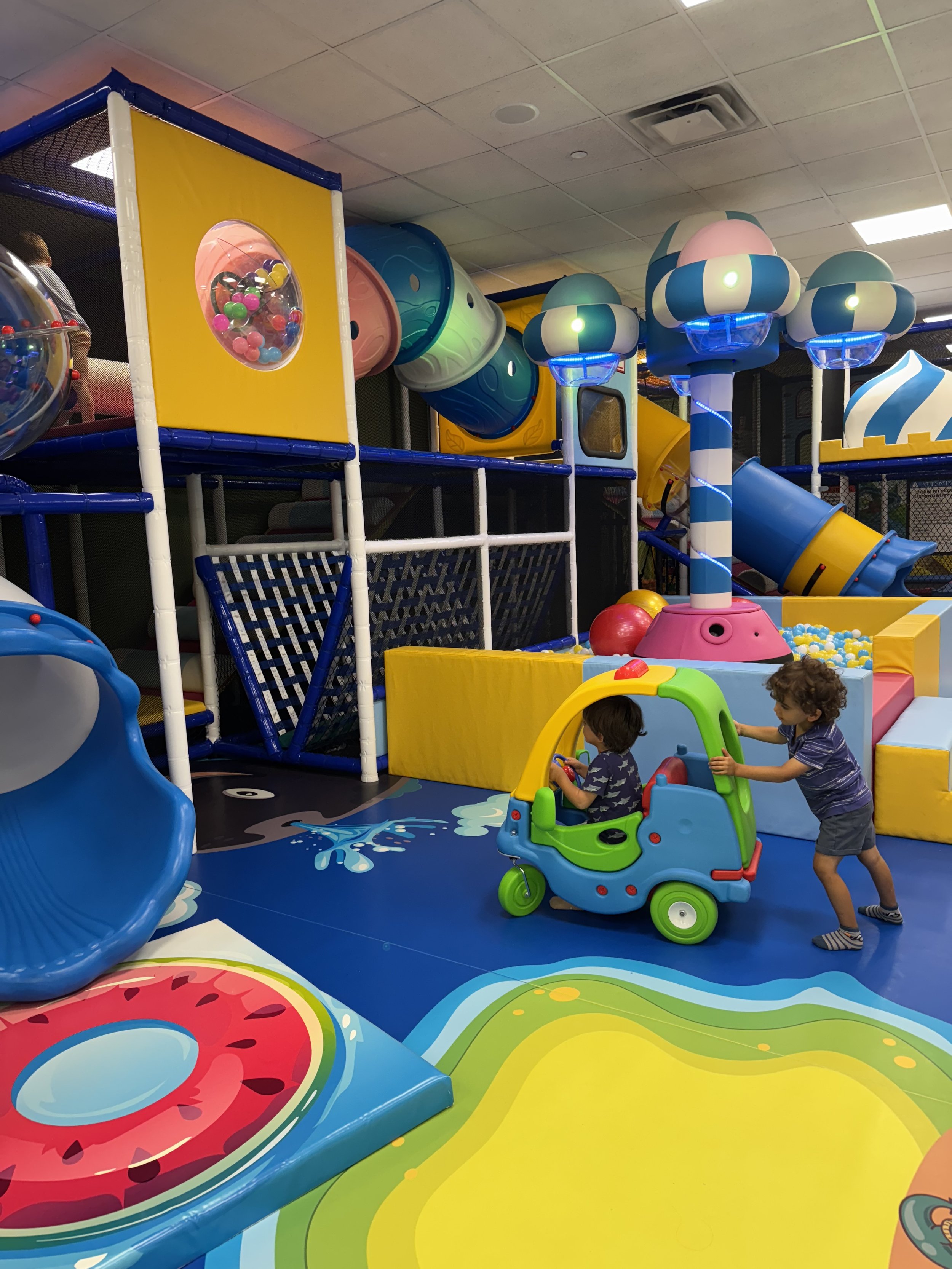 Colorful indoor play equipment at JJ's Playhouse.
