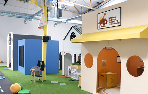 Pretend-play streetscape and house-front setup inside Jordan's Corner