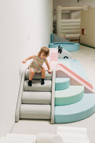 Toddler climbing setup with a small slide at Jordan's Corner