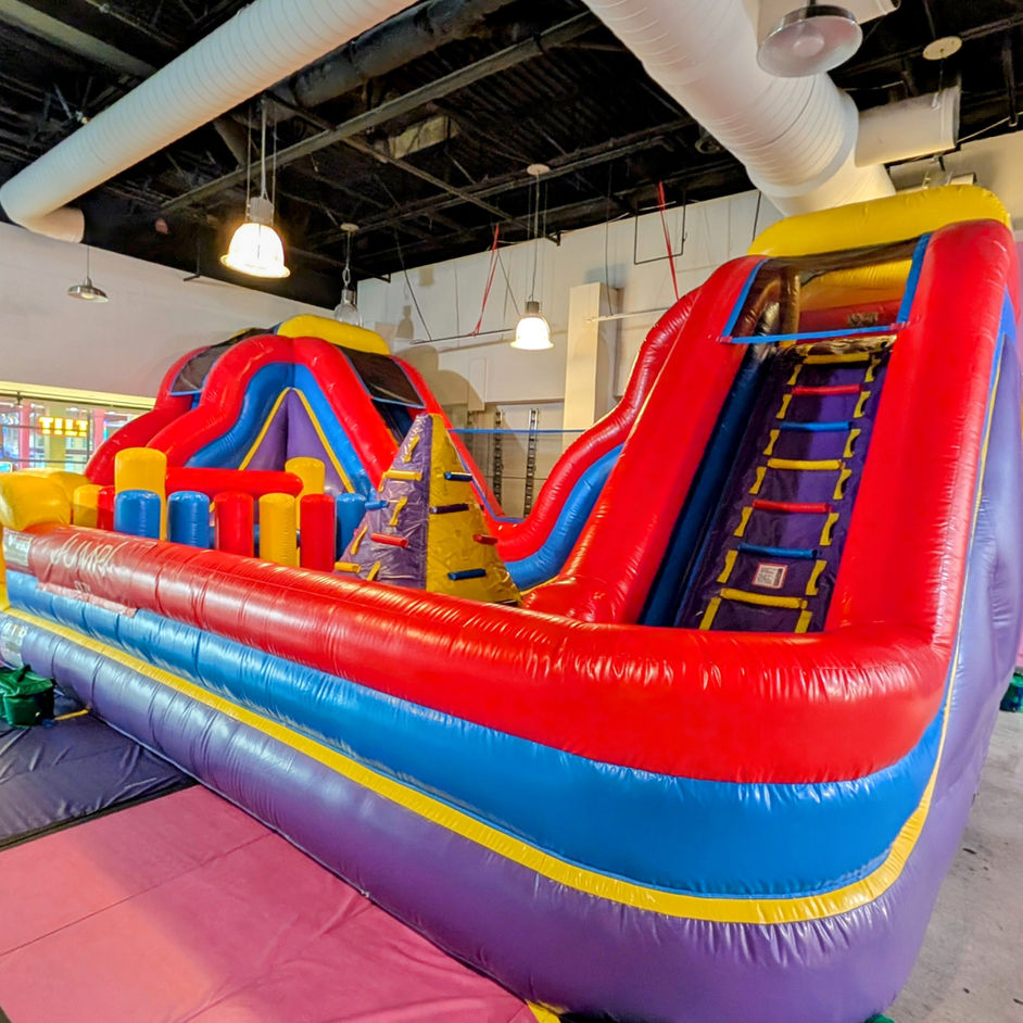 Kids using inflatable play equipment at Jump! City Tracy.