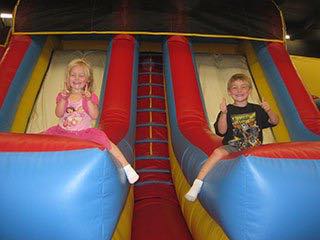 Children on an inflatable slide at Jump N Joy
