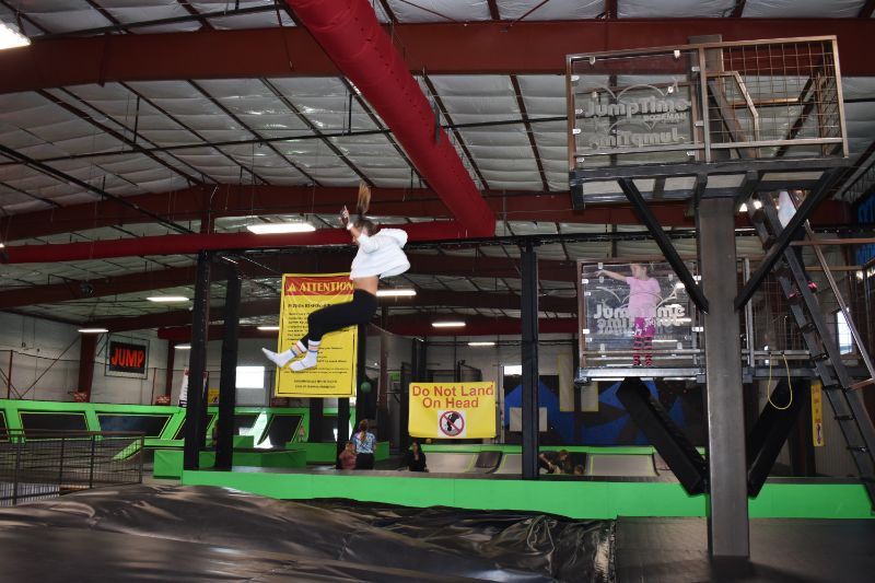 Child jumping from the Storm Castle Tower attraction at Jump Time Bozeman
