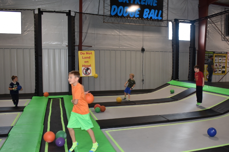 Children playing dodgeball on trampoline lanes at Jump Time Bozeman