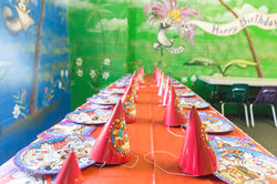 Long birthday party table set up inside a private party room at Jumpers Indoor Fun Zone