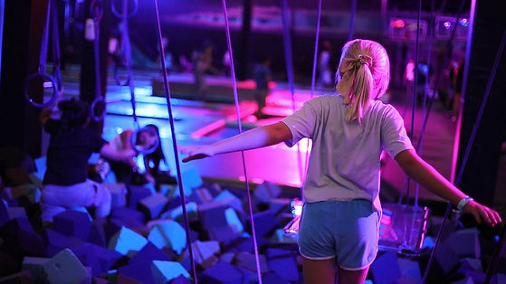Kids playing across the trampoline and attraction area at Jumping Cholla Trampoline Park in Tucson.