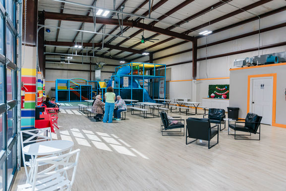 Open seating and play-floor view inside Kid Zone.