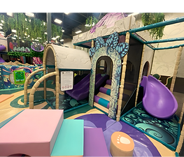 Lower toddler-friendly play area with soft shapes and small slides at Kidcadia.