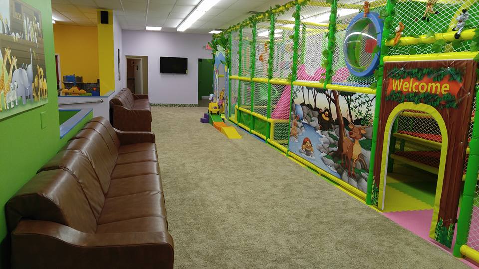 Seating area beside the play structure at Kiddie Jungle Mentor.