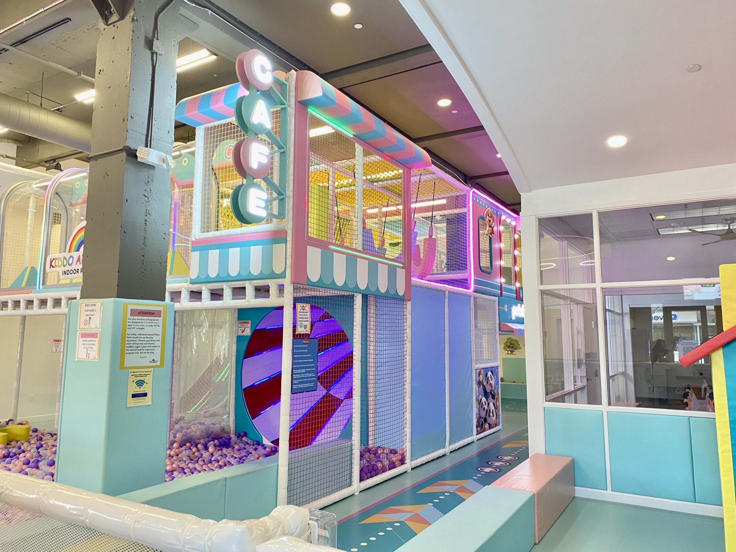 Front cafe and seating area beside the play structure at Kiddo Adventure.