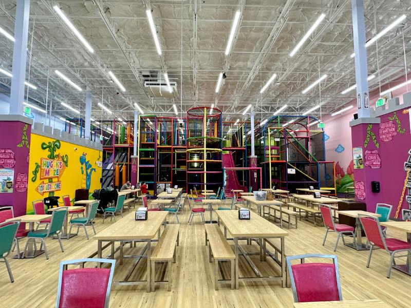 Large indoor play structure with slides at Kids Empire Kalamazoo.