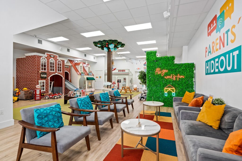 Parent lounge seating overlooking the play floor at Kids Hideout.