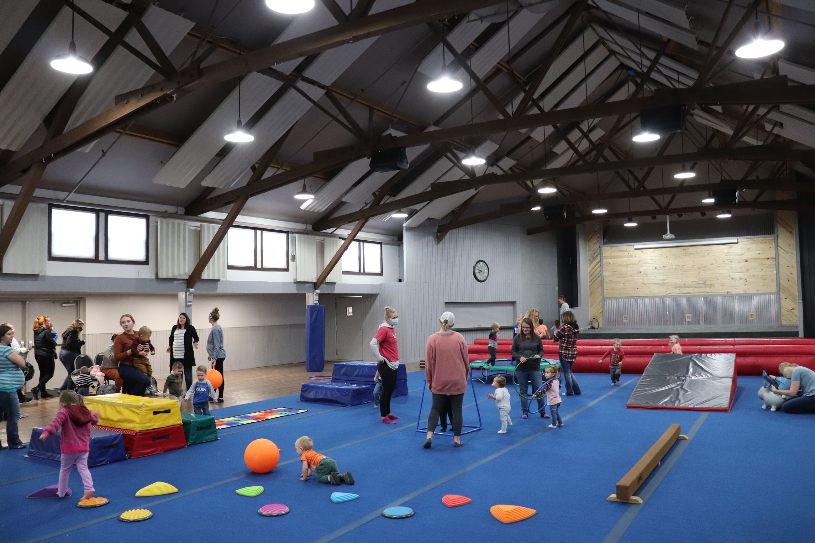 Children and caregivers using balance and movement equipment at Kids in Motion