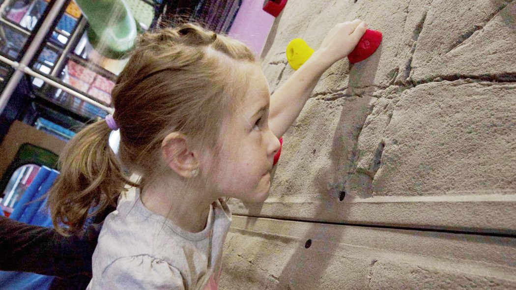Child climbing wall at Kids Quest Northern Quest.