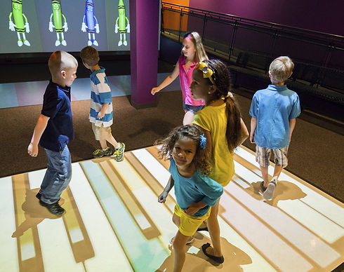 Kids using the piano-style interactive floor at Kid's Studio Play.