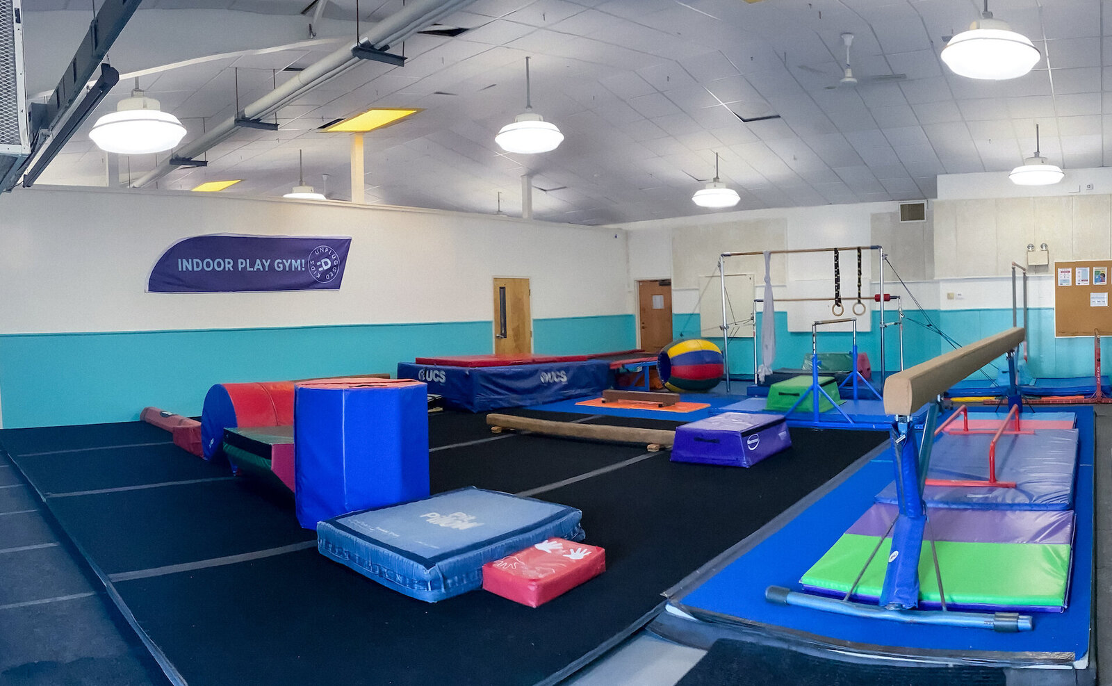 Gym floor at Kids Unplugged set up for active indoor play and movement.