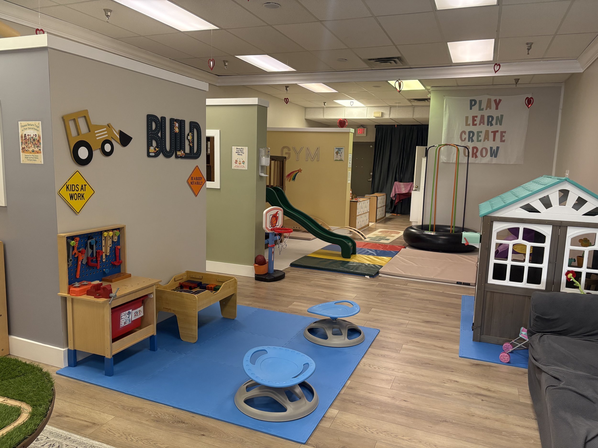 Open play area at Kidscape Playground with pretend-play stations and soft movement equipment.