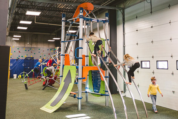 Children climbing and playing on KidSpark equipment inside Jackson Hole Indoor.