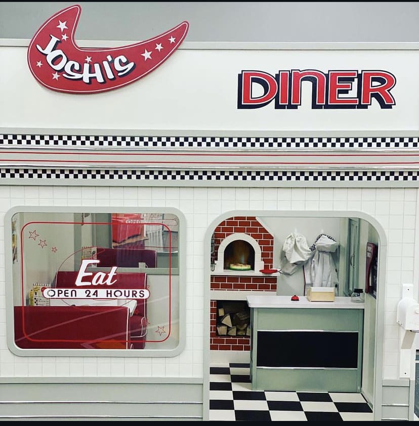 Pretend diner and playhouse area inside Kidz City.