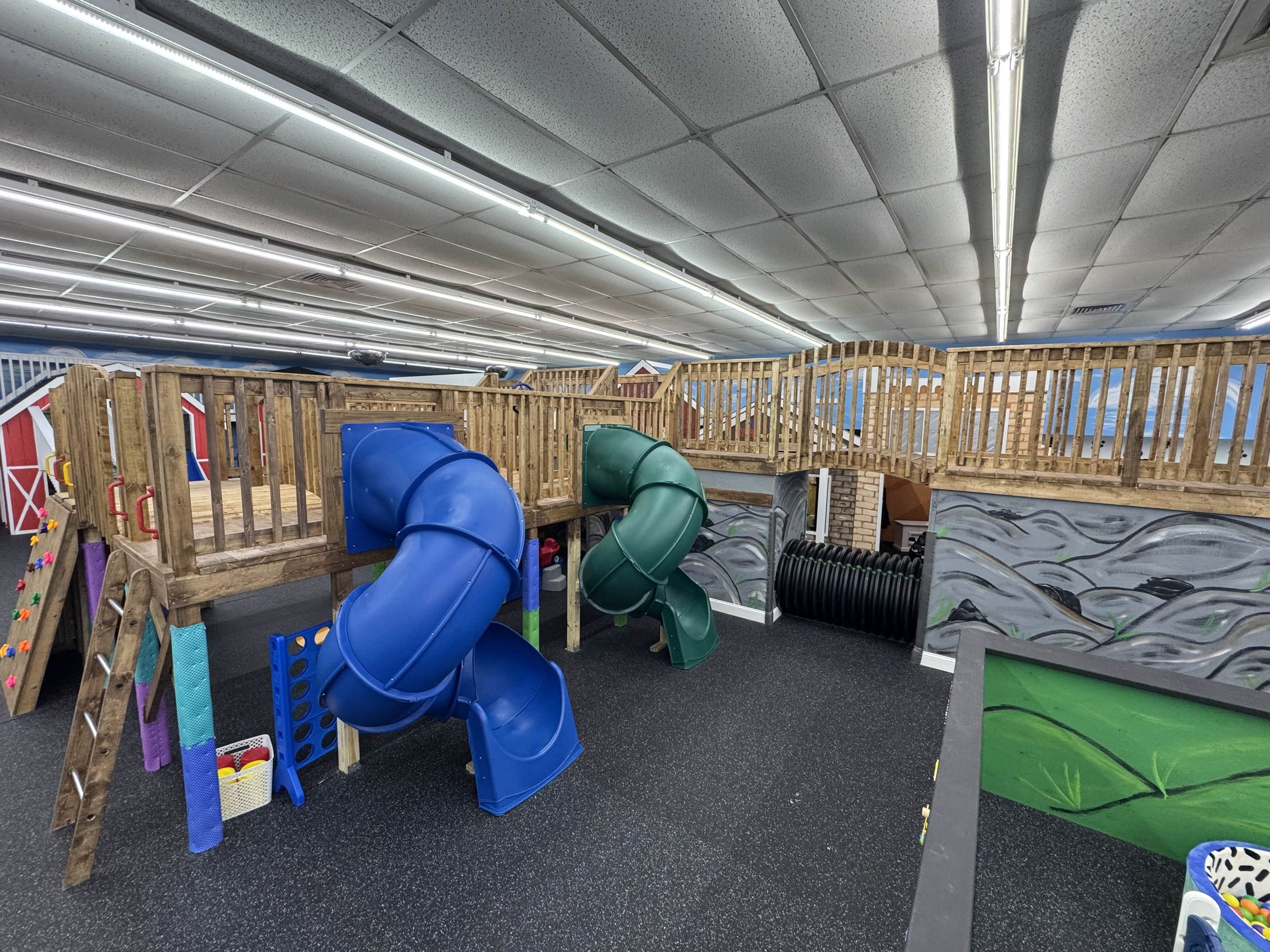 Play structure with tube slides inside KidZ Korner Party & Play