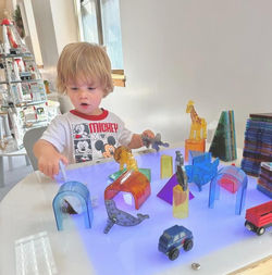 Toddler playing with translucent toys at Kidz Wishing Well