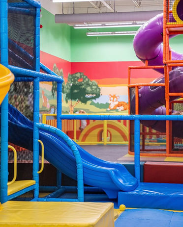 Soft-play structure with blue slide and climbing features inside Kidzville Catonsville.