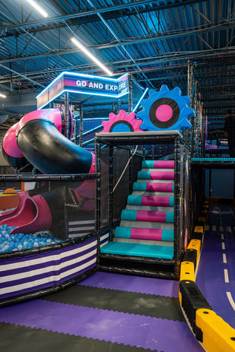 Indoor playground structure with slides and colorful padded flooring at Kidzville Nottingham.