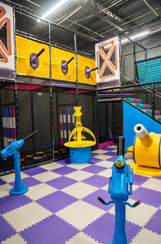 Colorful activity zone with interactive play cannons and soft flooring at Kidzville Nottingham.