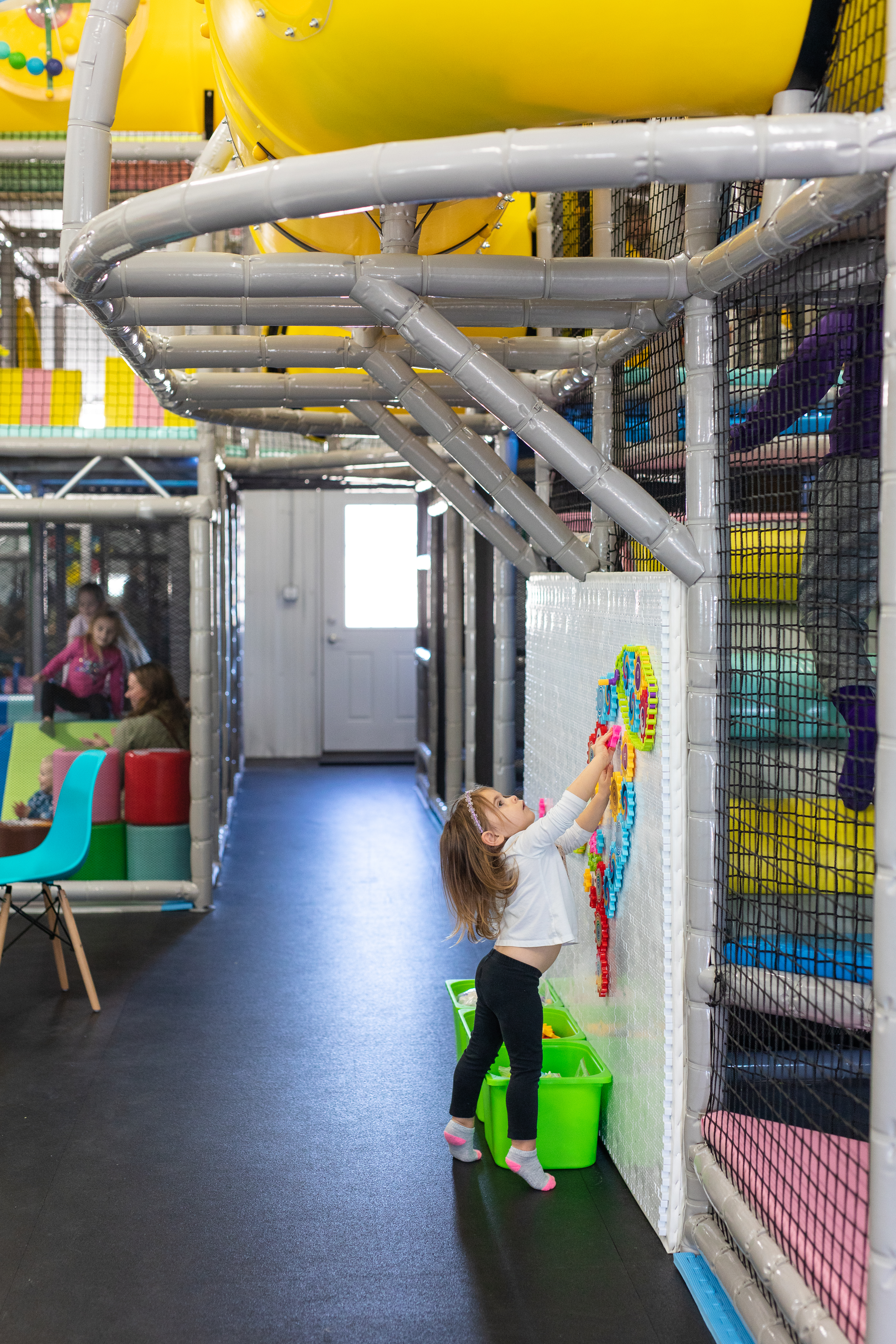 Children’s indoor playground area at KinderZone with padded play features.