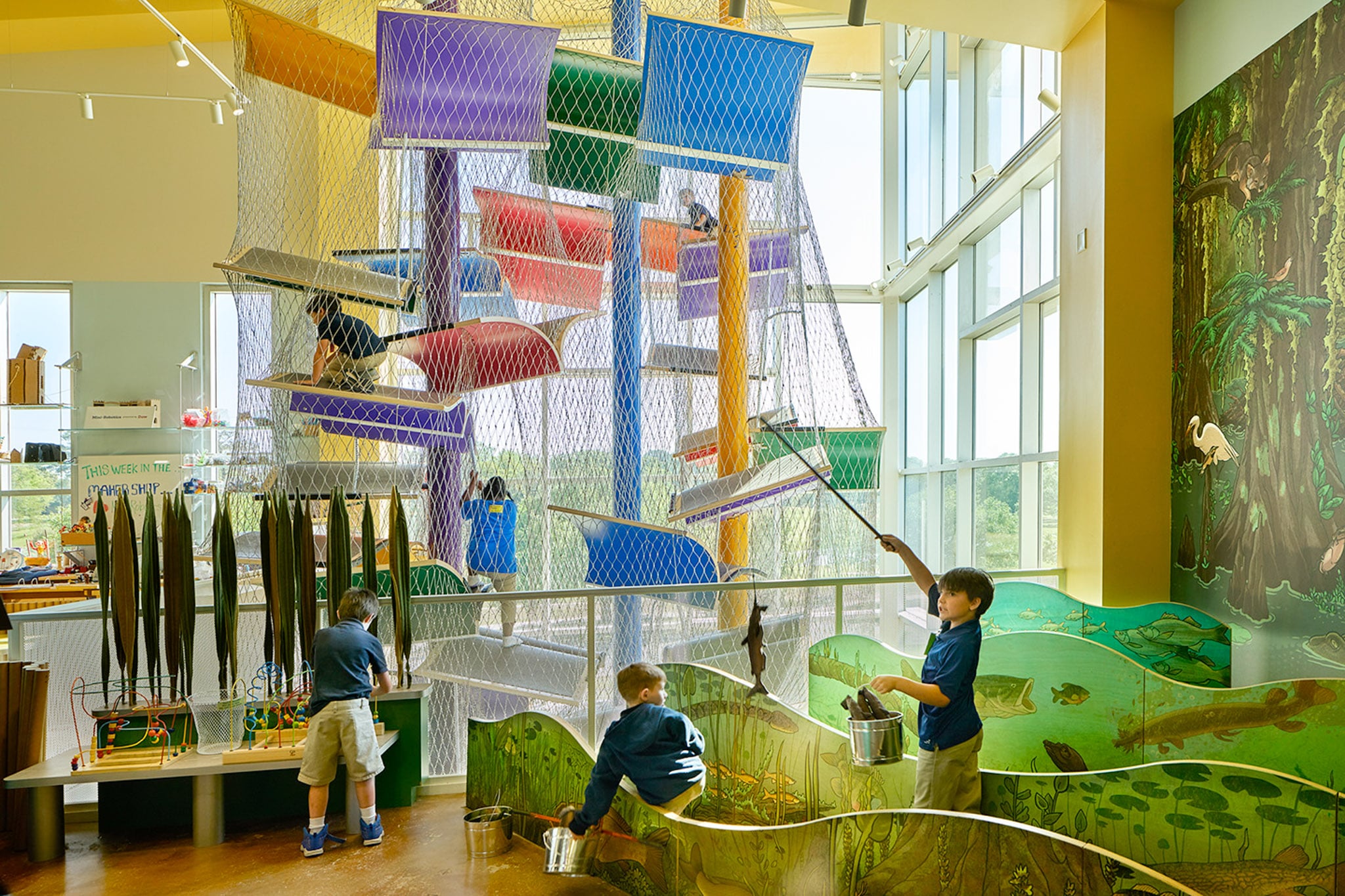 Children playing near the climbing and exploration area at Knock Knock Children's Museum.