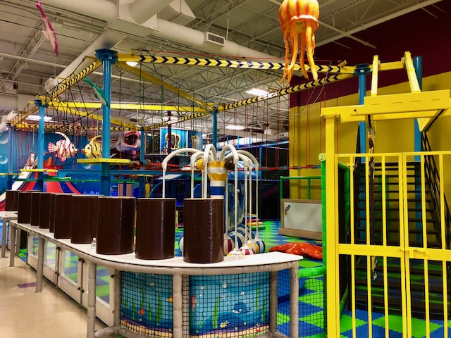 Play structure and attraction area at La La Land Boca Raton.