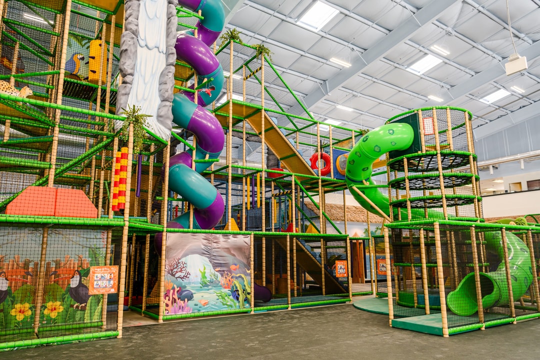 Twisty slides and connected climbing structure at Lava Island Billings.