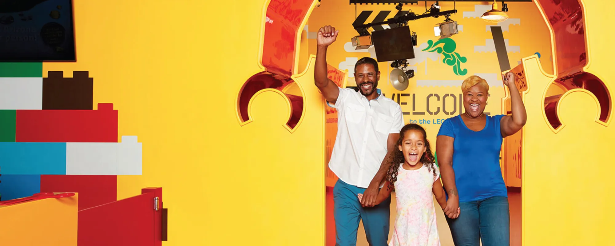 Family at the entrance to LEGOLAND Discovery Center Michigan.