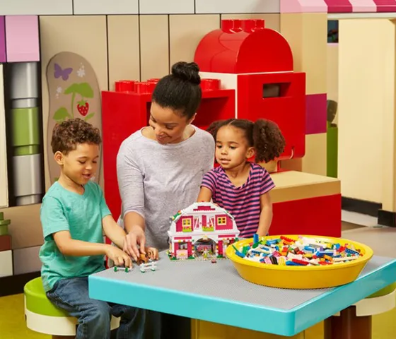 Children exploring a colorful LEGO Friends themed area at the attraction