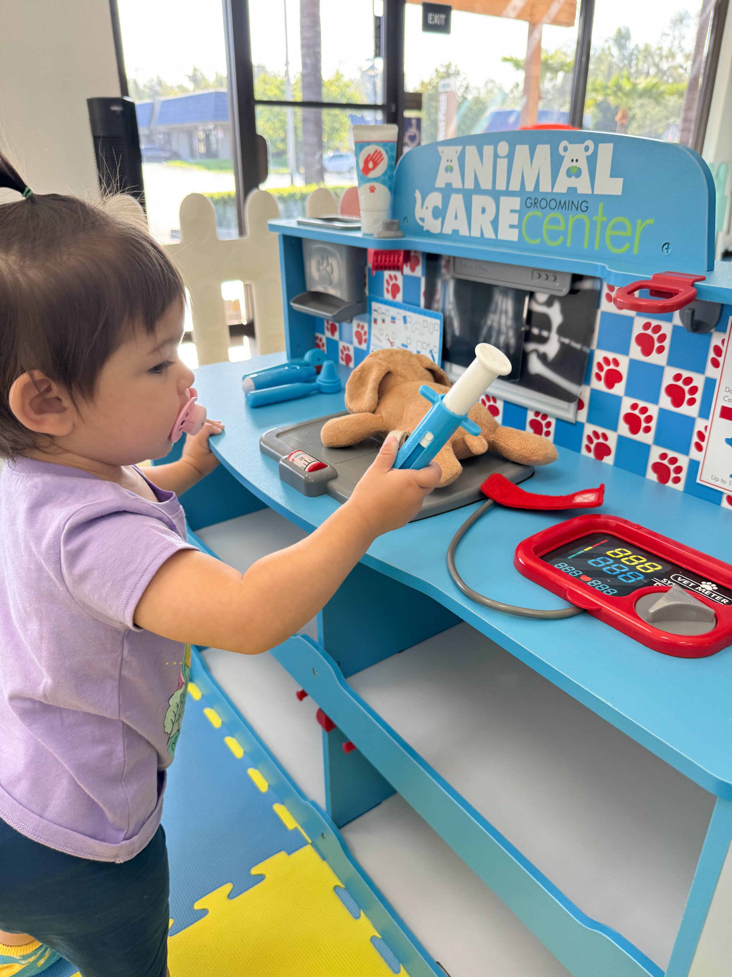 Play area with toddler-scale equipment at Lil’ Munchkins Indoor Playground.