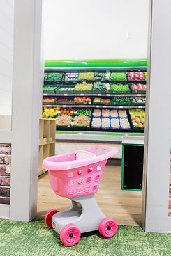 Pretend grocery play area inside Little Explorers Play Cafe.