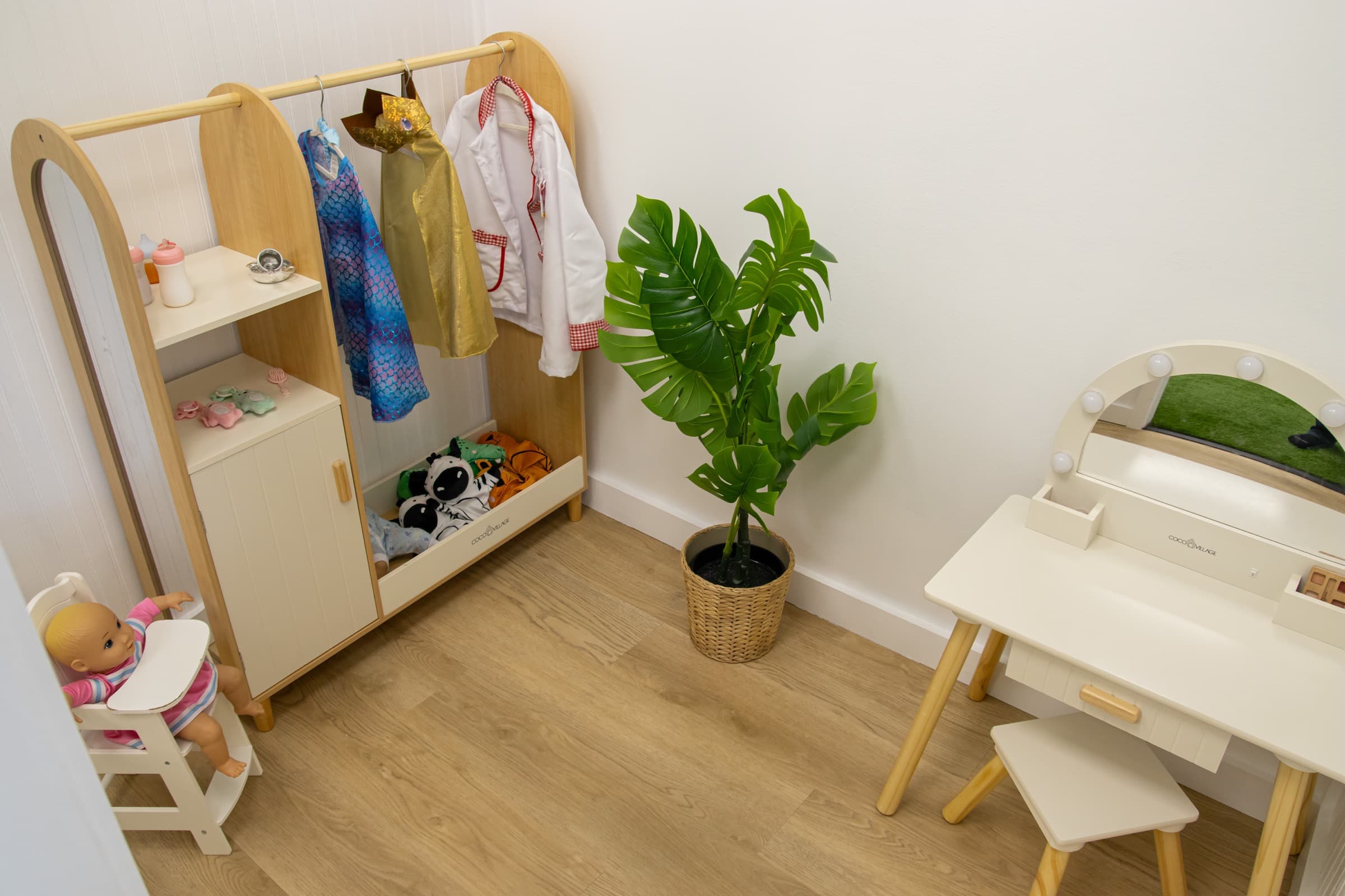 Dress-up and vanity corner with costumes at Little Leaps Play-Cafe.