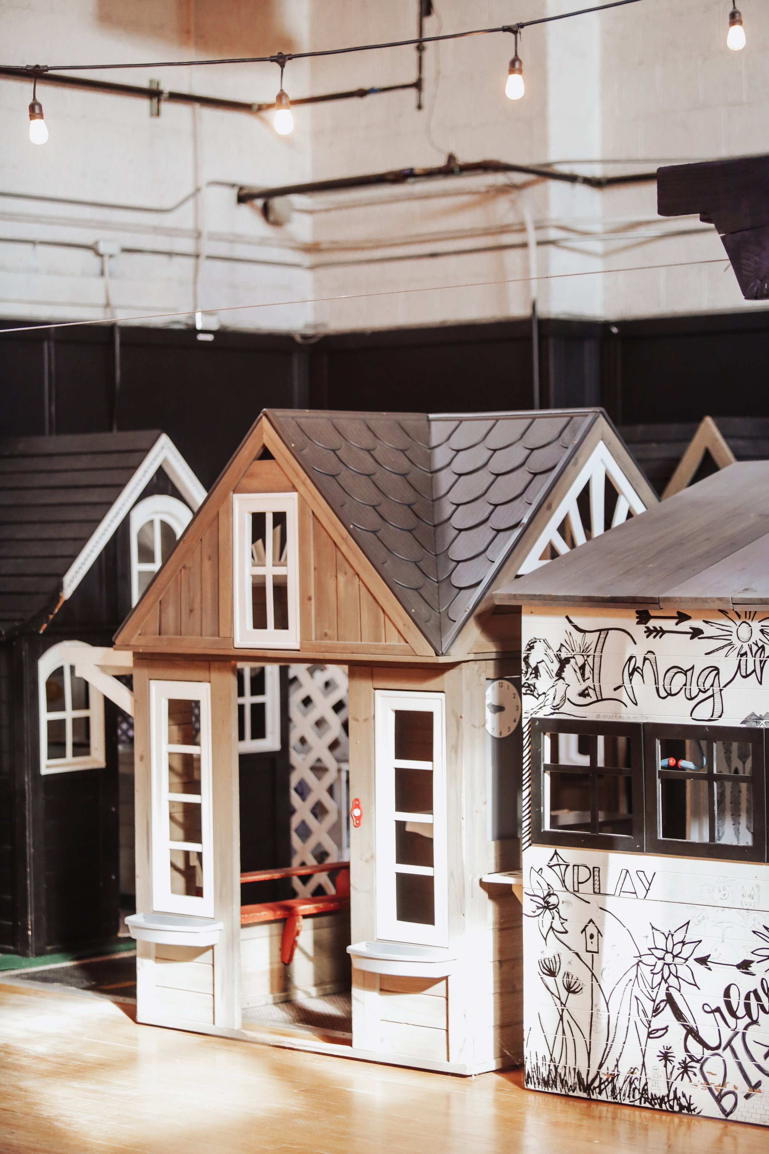 Mini city storefronts and playhouses at Little Midland